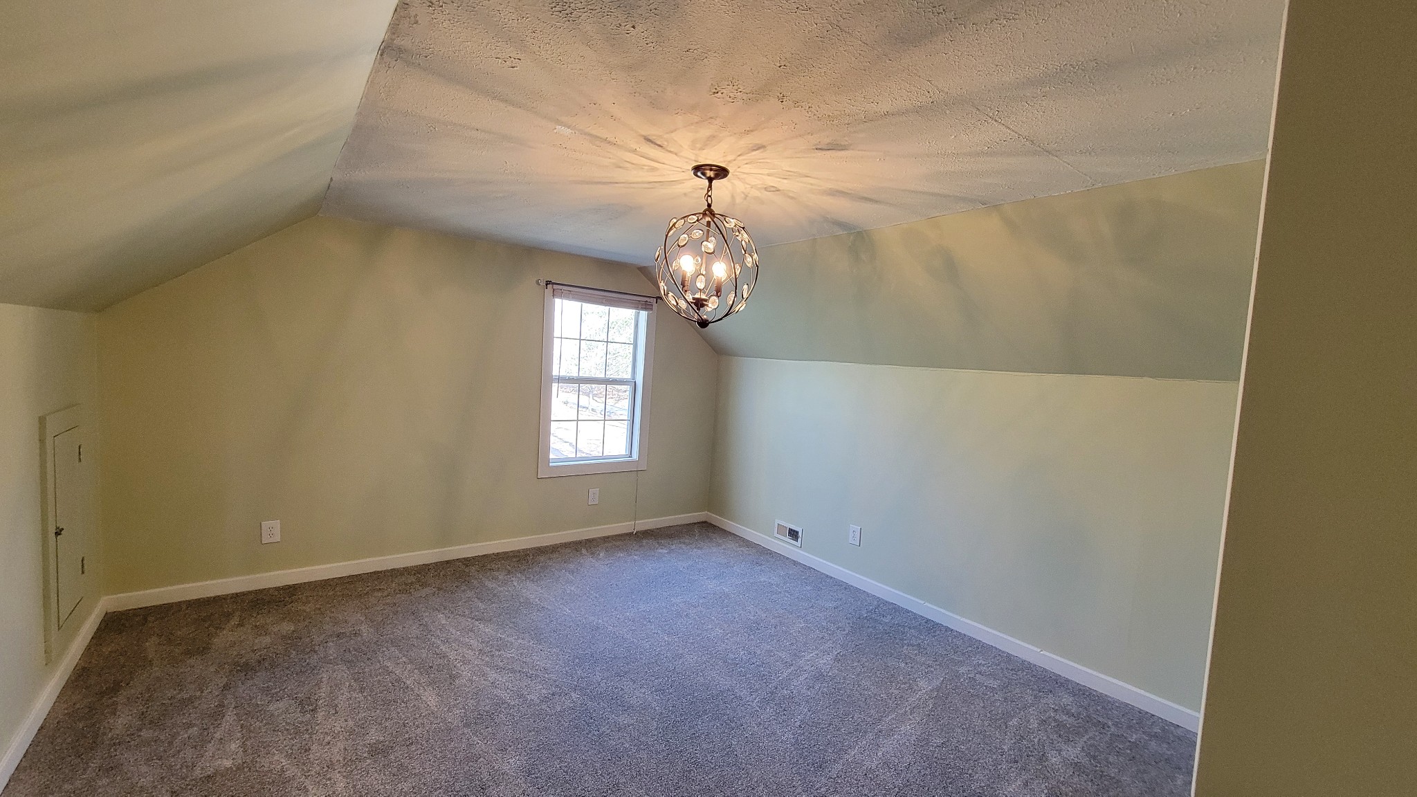 1678 4 Seasons Road Smithville, TN 37166 - Photo 35 of 43 an empty room that has a chandelier fan and wooden floor