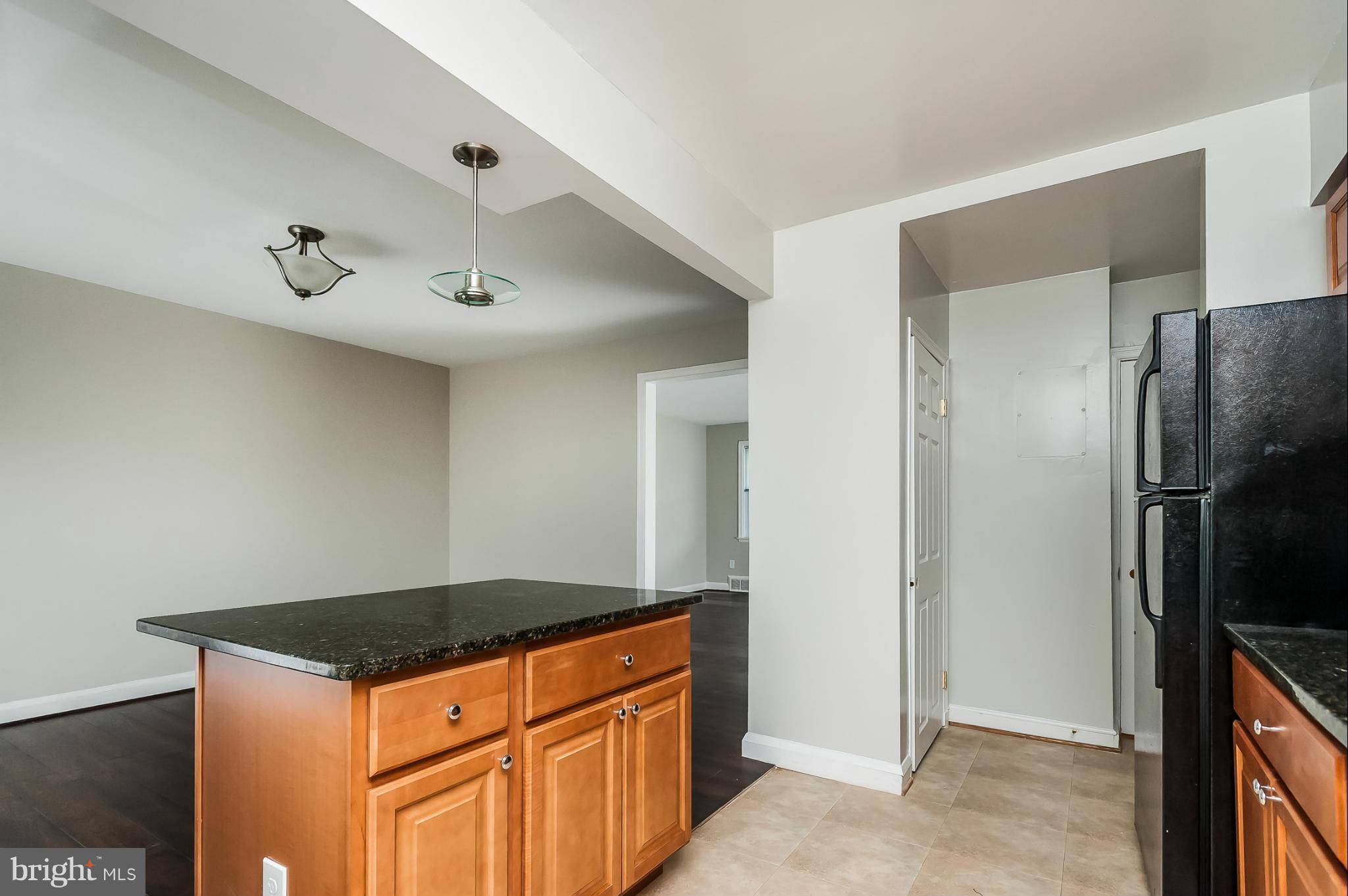1382 Pentwood Road Baltimore, MD 21239 - Photo 8 of 30 a kitchen with stainless steel appliances granite countertop a refrigerator and a stove