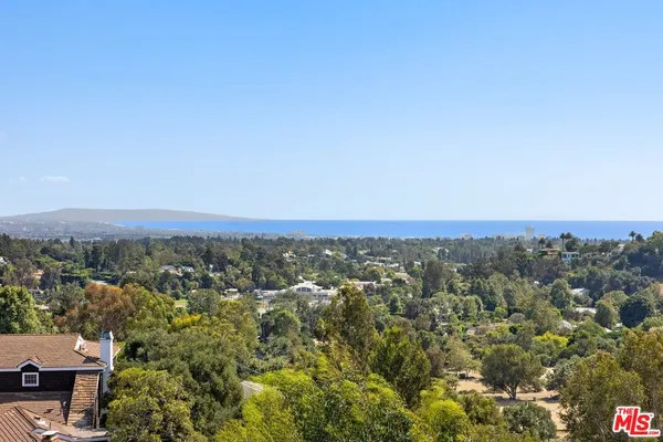 a large white bathroom with a large mirror vanity and shower