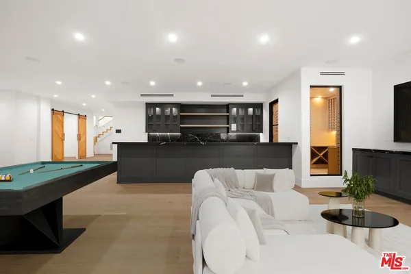 a living room with furniture and a projector screen