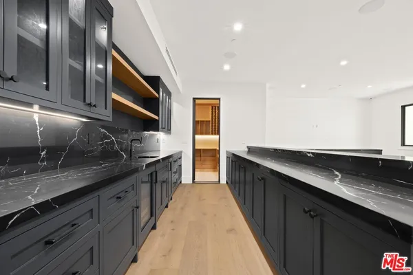 a view of a livingroom with hardwood floor and a flat screen tv