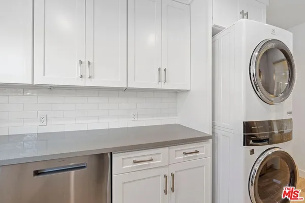a utility room with sink dryer and washer