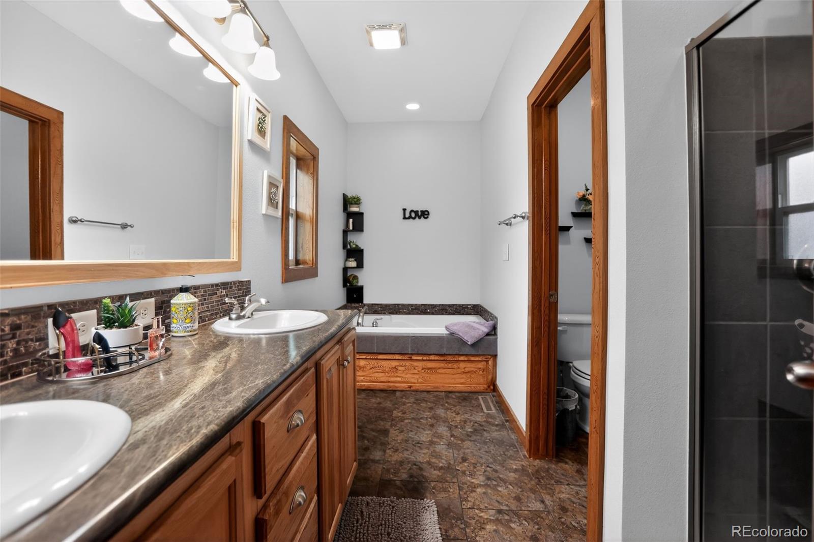 10 Salmon Loop Gypsum, CO 81637 - Photo 13 of 15 a bathroom with a granite countertop sink and a mirror