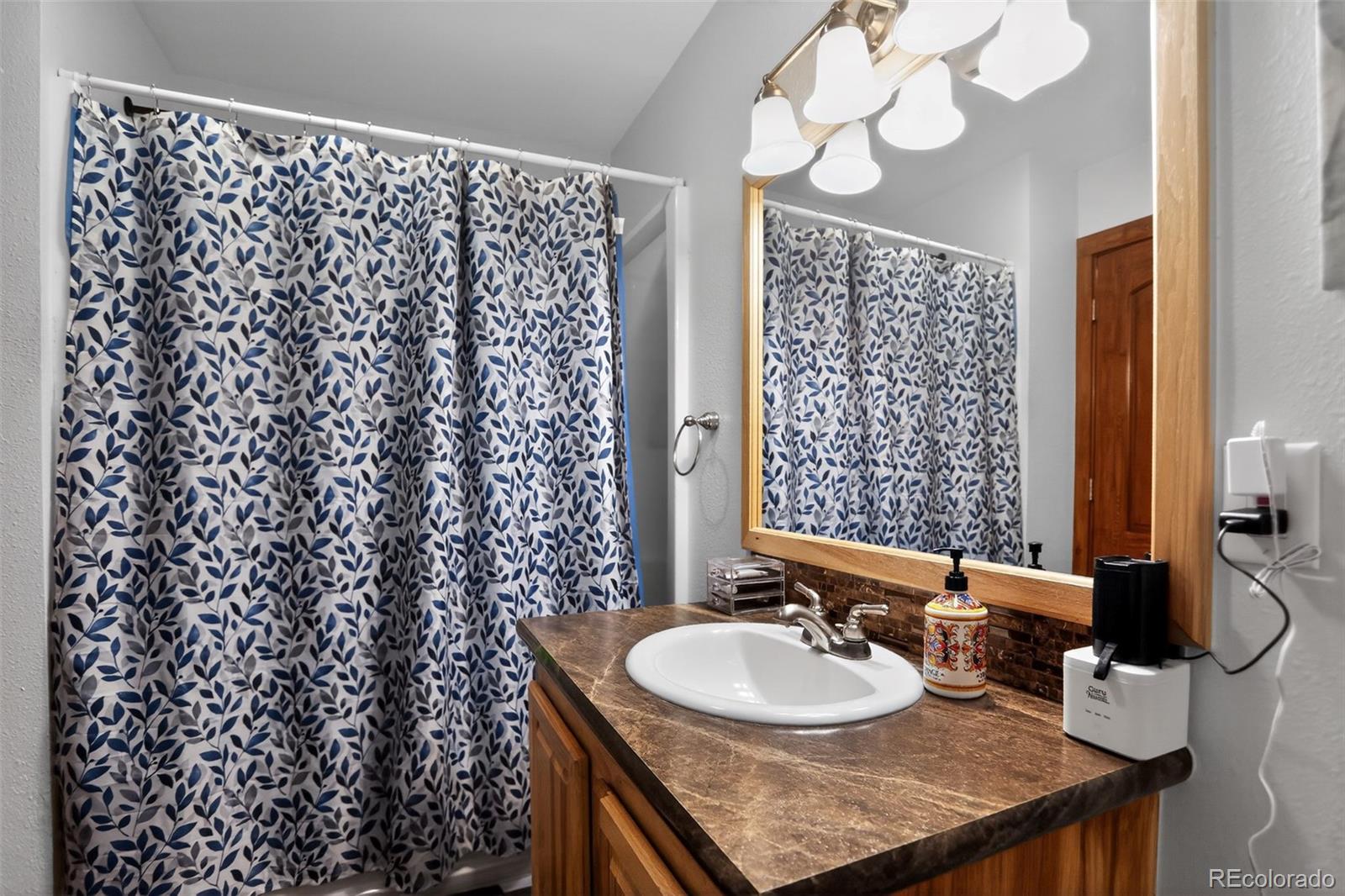 10 Salmon Loop Gypsum, CO 81637 - Photo 15 of 15 a bathroom with a sink a mirror and a shower curtain