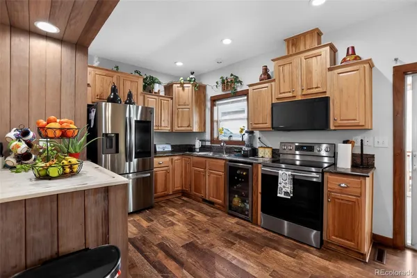 a kitchen with stainless steel appliances a stove refrigerator sink and cabinets