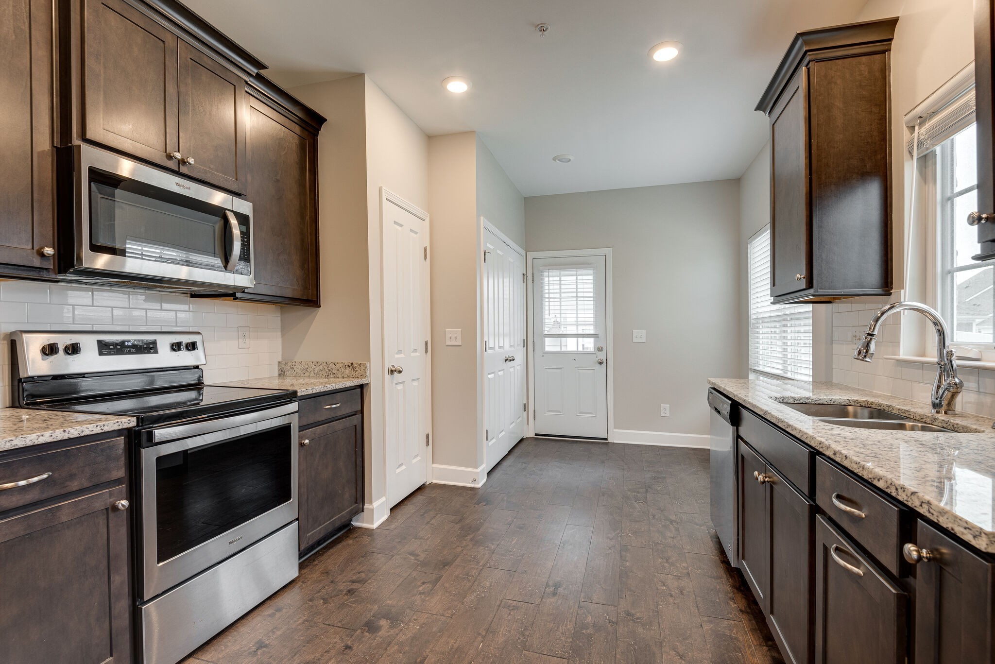 269 Mary Ann Circle Spring Hill, TN 37174 - Photo 8 of 28 a kitchen with stainless steel appliances granite countertop a sink stove and microwave