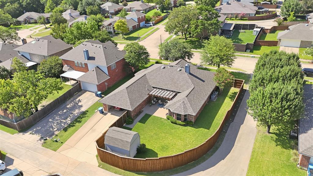 4218 Glistening Spring Rowlett, TX 75088 - Photo 36 of 39 Expansive corner lot featuring a single-story residence with a multi-gabled roofline and an attached garage