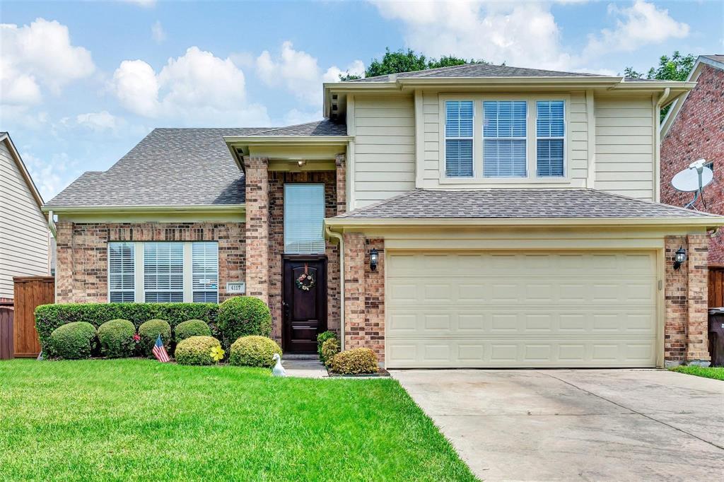 a front view of a house with a garden and plants