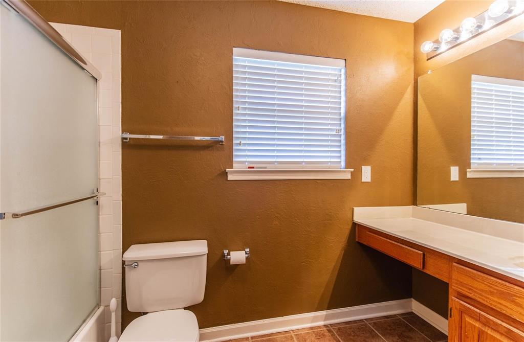 4117 Oxlea Drive Plano, TX 75024 - Photo 13 of 17 a bathroom with a toilet a sink and a window