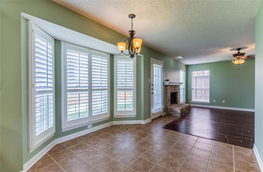 4117 Oxlea Drive Plano, TX 75024 - Photo 6 of 17 a view of an empty room with window and wooden floor
