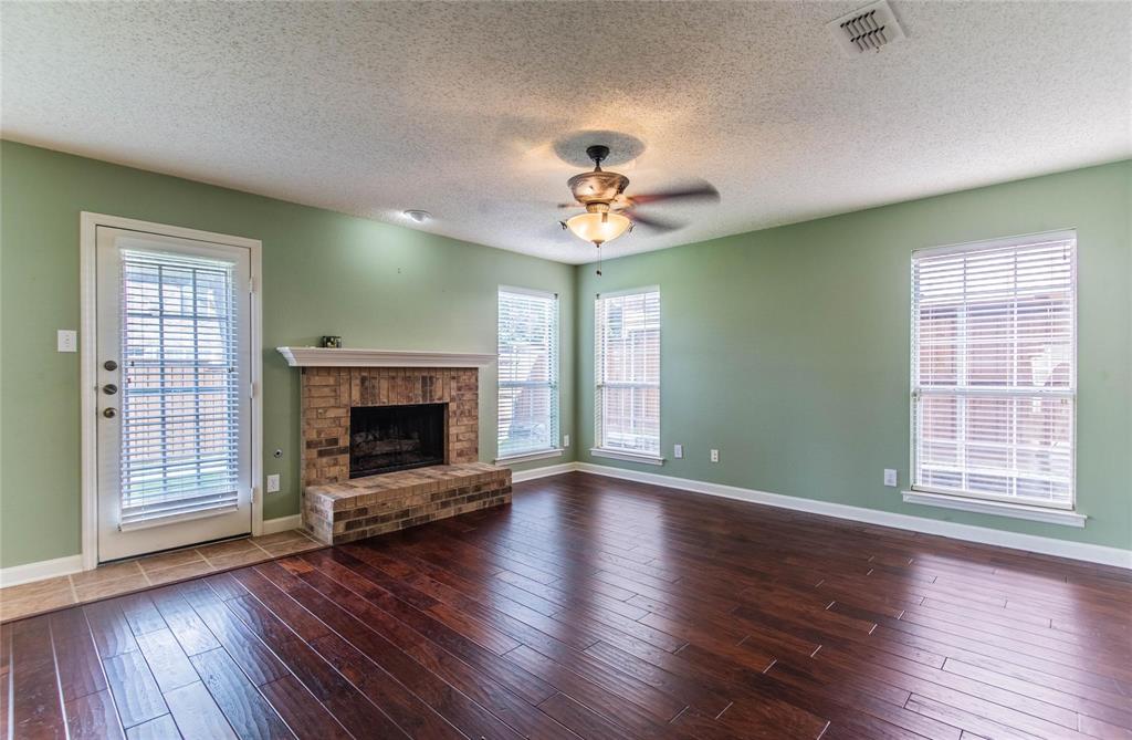 4117 Oxlea Drive Plano, TX 75024 - Photo 9 of 17 a view of an empty room with a fireplace and a window