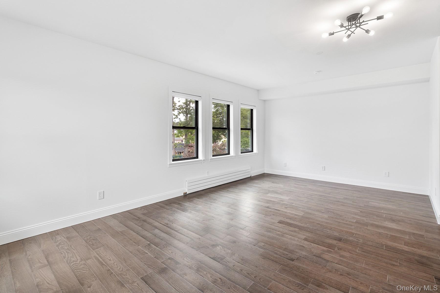 206-208 Main Street, Unit 1 Beacon, NY 12508 - Photo 7 of 12 a view of an empty room with wooden floor and a window