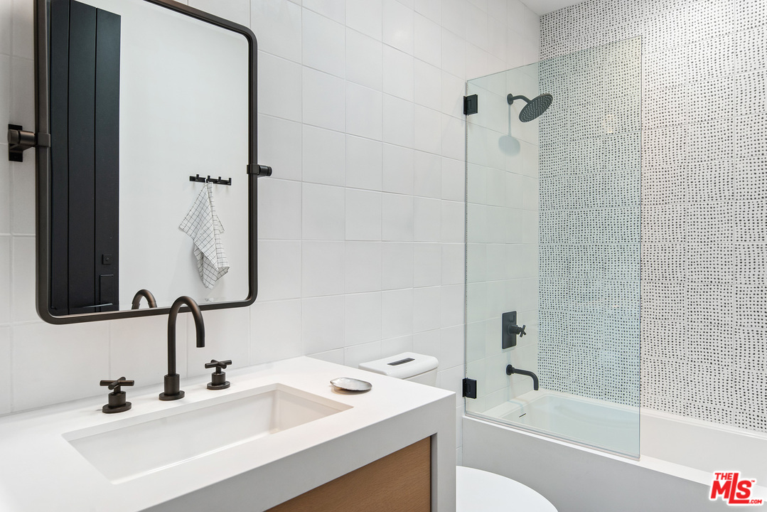 6530 Zuma View Place Malibu, CA 90265 - Photo 16 of 31 a bathroom with a sink and a mirror