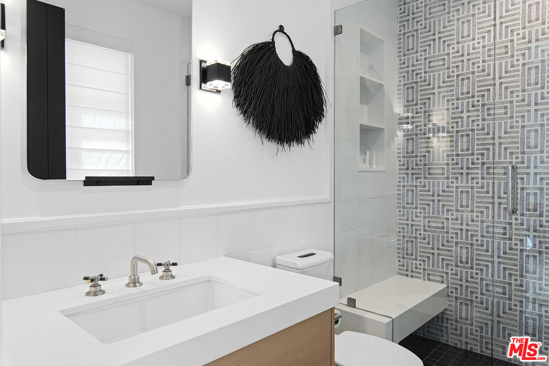 6530 Zuma View Place Malibu, CA 90265 - Photo 17 of 31 a bathroom with a sink a toilet and a mirror