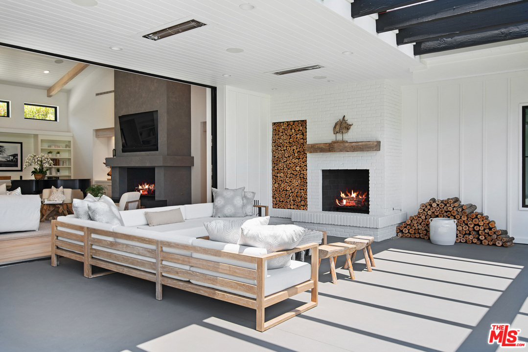 6530 Zuma View Place Malibu, CA 90265 - Photo 21 of 31 a living room with furniture and a fireplace