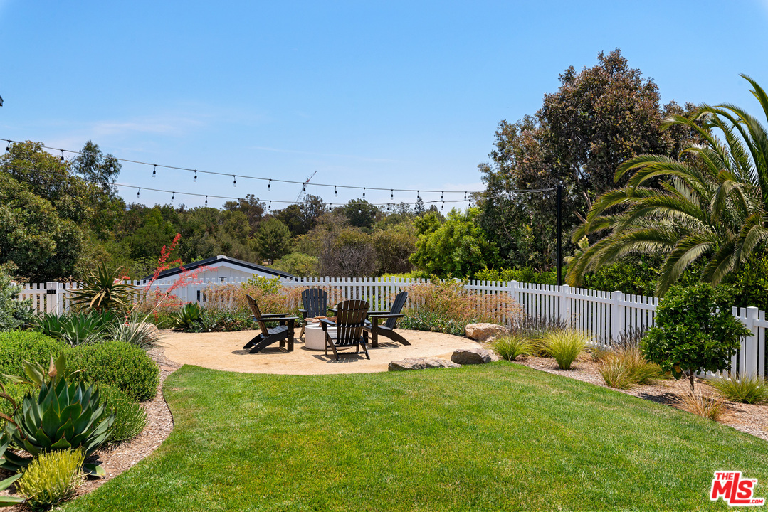 6530 Zuma View Place Malibu, CA 90265 - Photo 24 of 31 a view of a lake with a table and chairs
