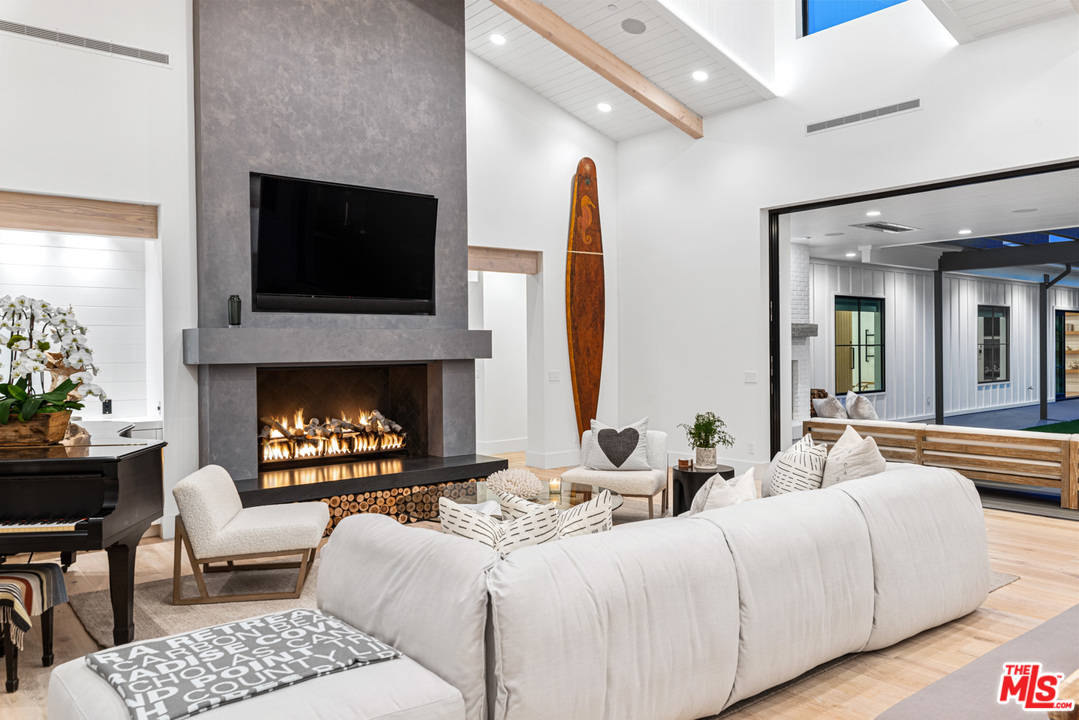 6530 Zuma View Place Malibu, CA 90265 - Photo 29 of 31 a living room with furniture fireplace and flat screen tv