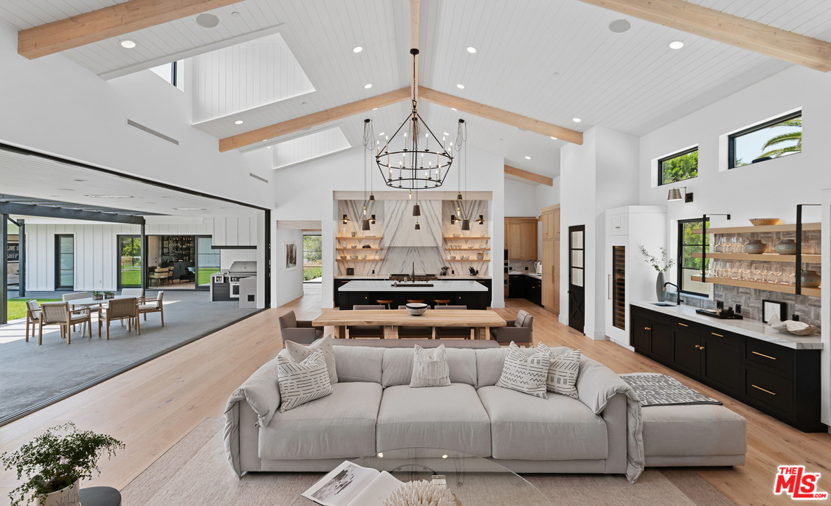 6530 Zuma View Place Malibu, CA 90265 - Photo 7 of 31 a living room with furniture chandelier and a large window