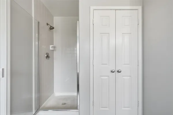 a bathroom with a glass shower door
