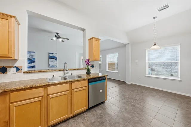 a kitchen with a sink and cabinets