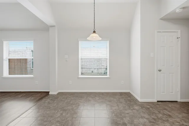 a room that has a window in it and a chandelier