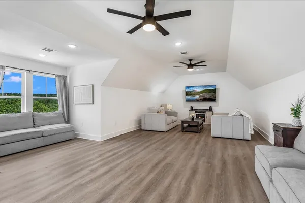 a living room with lots of furniture and a flat screen tv