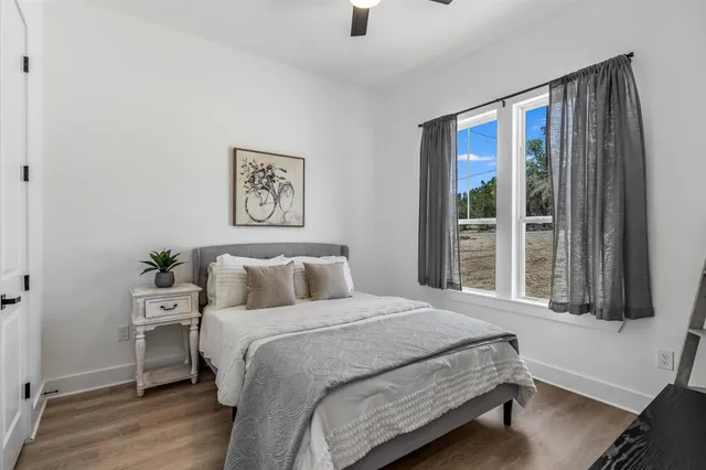 a bedroom with a large bed and a window