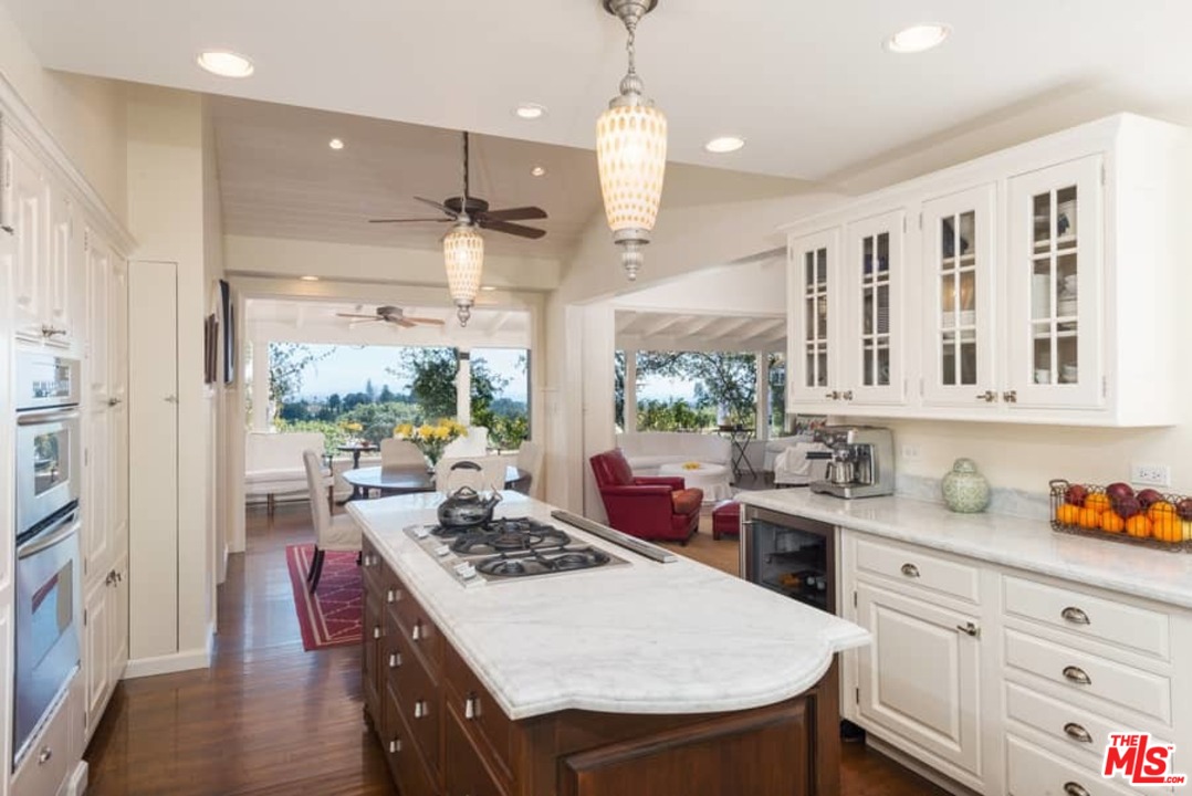 1766 Westridge Road Los Angeles, CA 90049 - Photo 21 of 54 a kitchen with a stove a sink dishwasher and a refrigerator with wooden floor