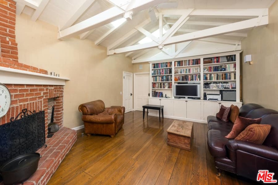 1766 Westridge Road Los Angeles, CA 90049 - Photo 27 of 54 a living room with furniture and a fireplace