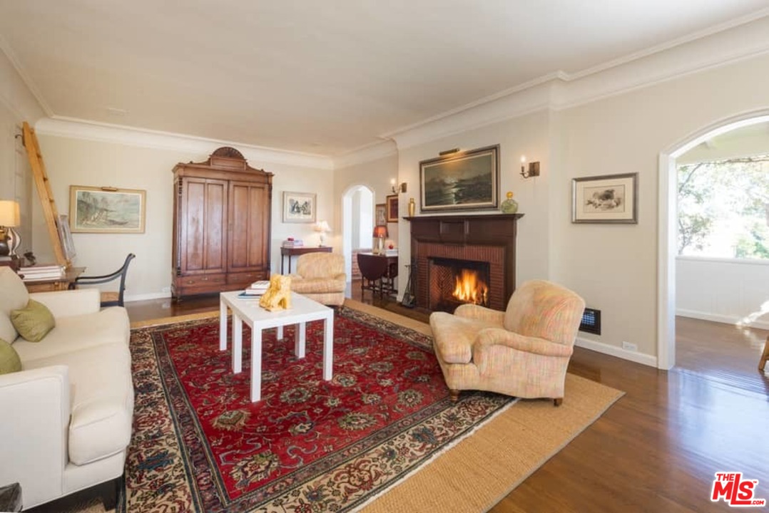 1766 Westridge Road Los Angeles, CA 90049 - Photo 33 of 54 a living room with furniture a fireplace and a table