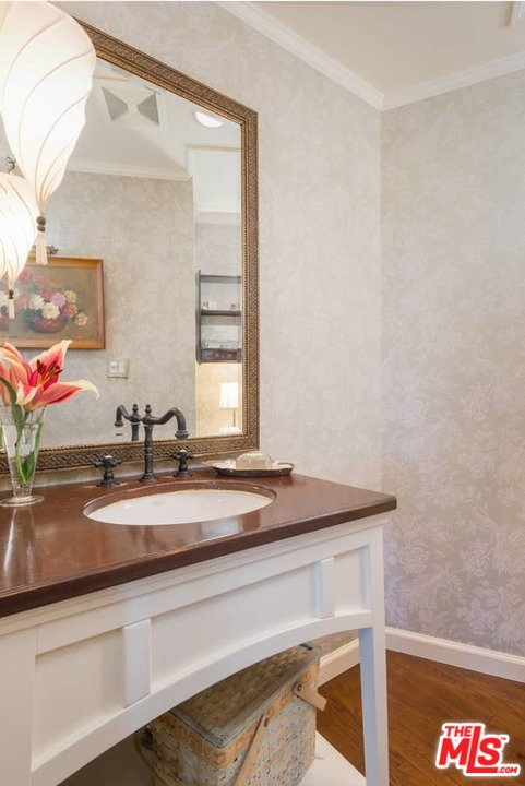 1766 Westridge Road Los Angeles, CA 90049 - Photo 37 of 54 a bathroom with a sink and a mirror
