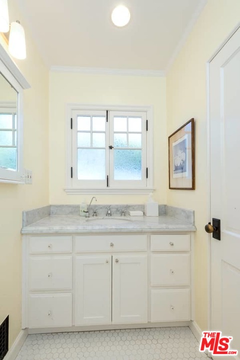 1766 Westridge Road Los Angeles, CA 90049 - Photo 42 of 54 a bathroom with a granite countertop sink mirror and window