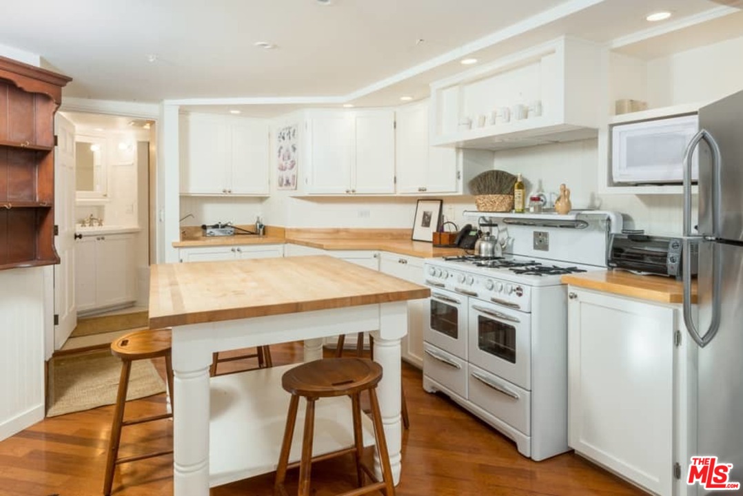 1766 Westridge Road Los Angeles, CA 90049 - Photo 54 of 54 a kitchen with a stove a sink and a refrigerator