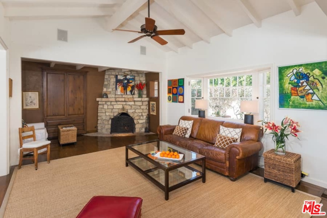 1766 Westridge Road Los Angeles, CA 90049 - Photo 9 of 54 a living room with furniture fireplace and flat screen tv