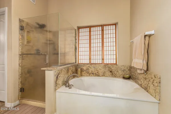 a white bath tub sitting next to a shower