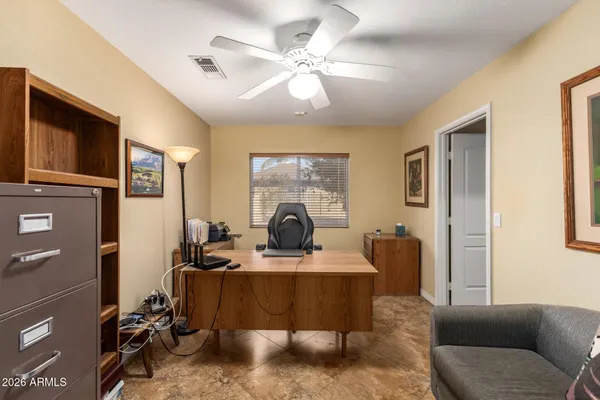 a living room with furniture a ceiling fan and a window