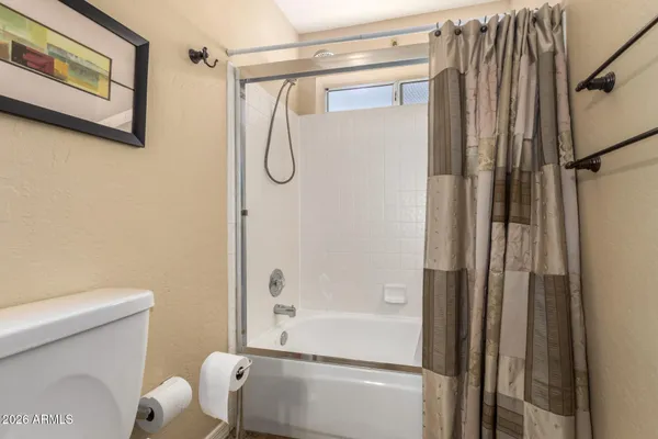 a bathroom with a shower and a toilet