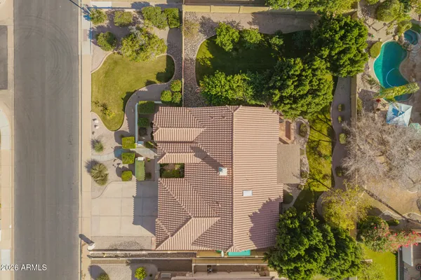 a view of a house with backyard and sitting area