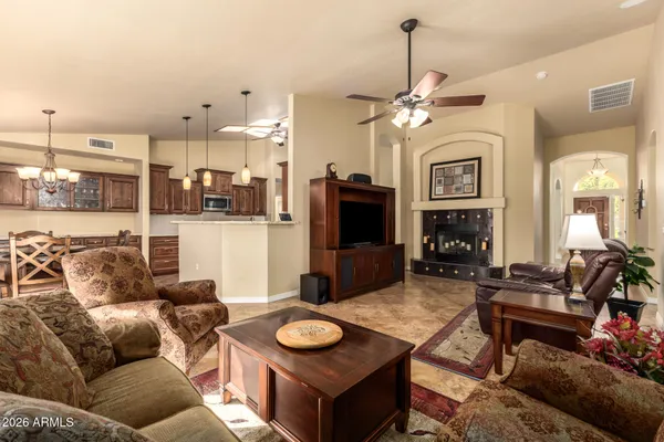 a living room with furniture a fireplace and a chandelier