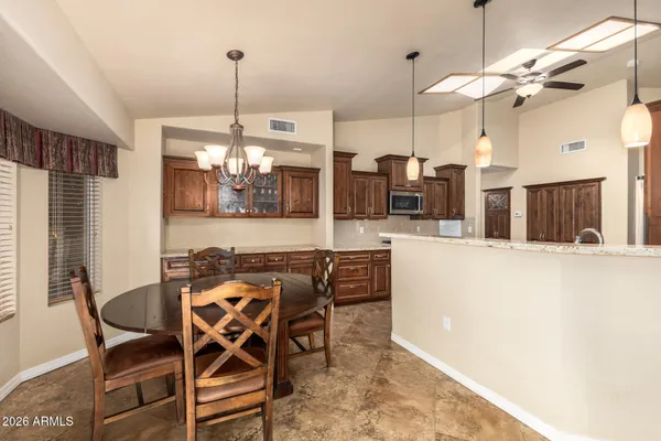 a view of a dining room with furniture and chandelier