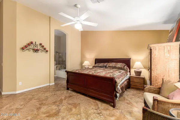 a spacious bedroom with a bed and a chandelier