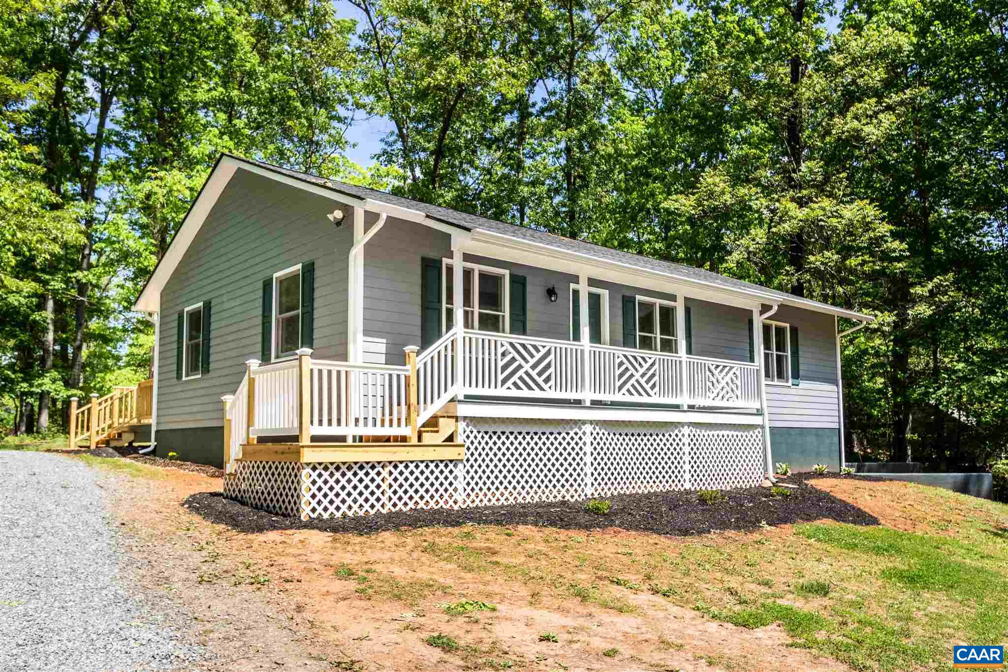 820 Geranium Road Ruckersville, VA 22968 - Photo 4 of 25 a front view of a house with a garden and yard