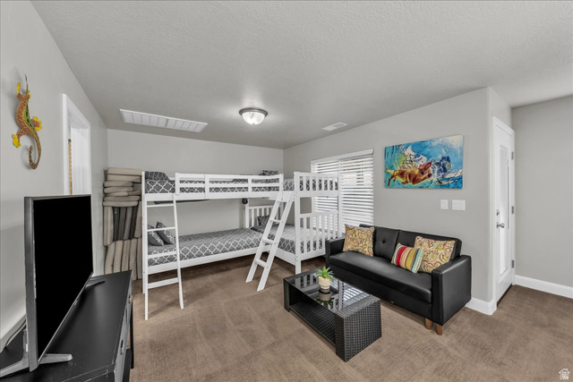 4796 Winged Foot Drive St. George, UT 84770 - Photo 30 of 33 Bedroom with carpet flooring and a textured ceiling