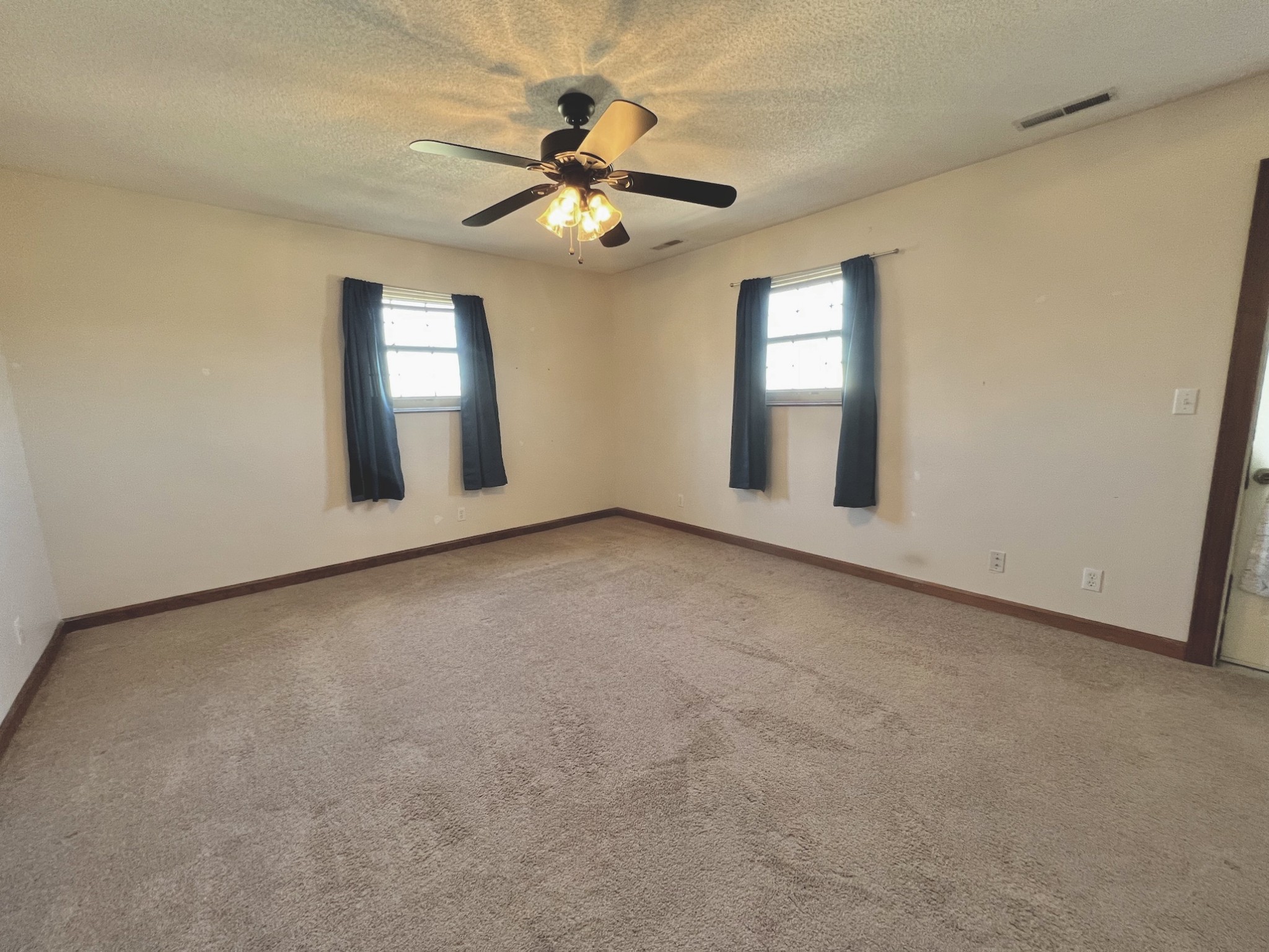 506 New Center Church Road Shelbyville, TN 37160 - Photo 17 of 44 an empty room with windows and fan