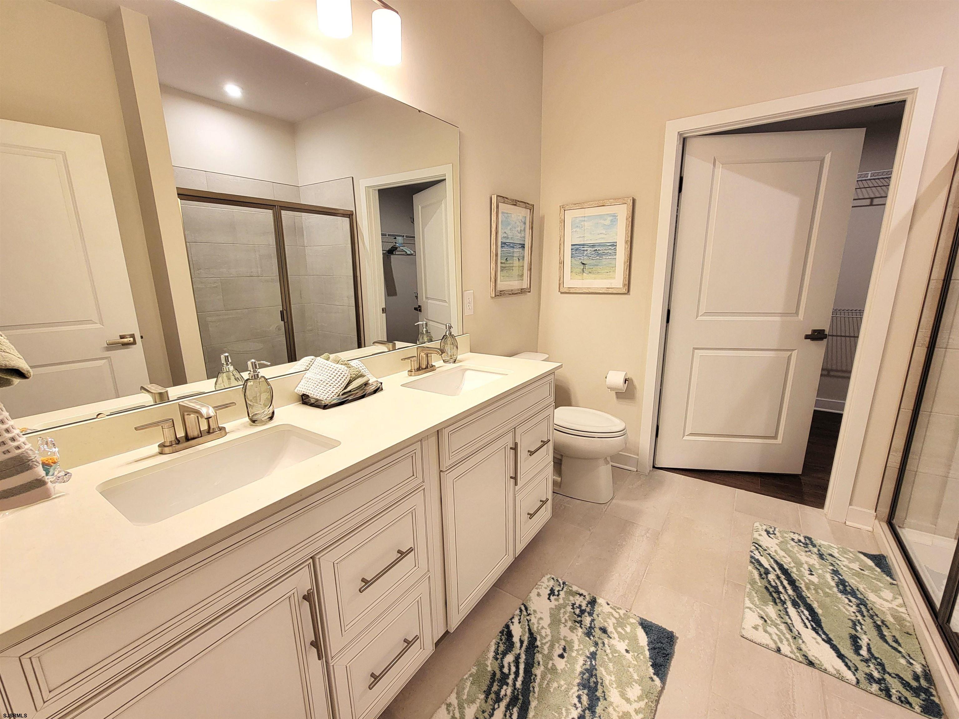 1004 Jesse Drive Somers Point, NJ 08244 - Photo 20 of 45 a spacious bathroom with a double vanity sink toilet and a mirror