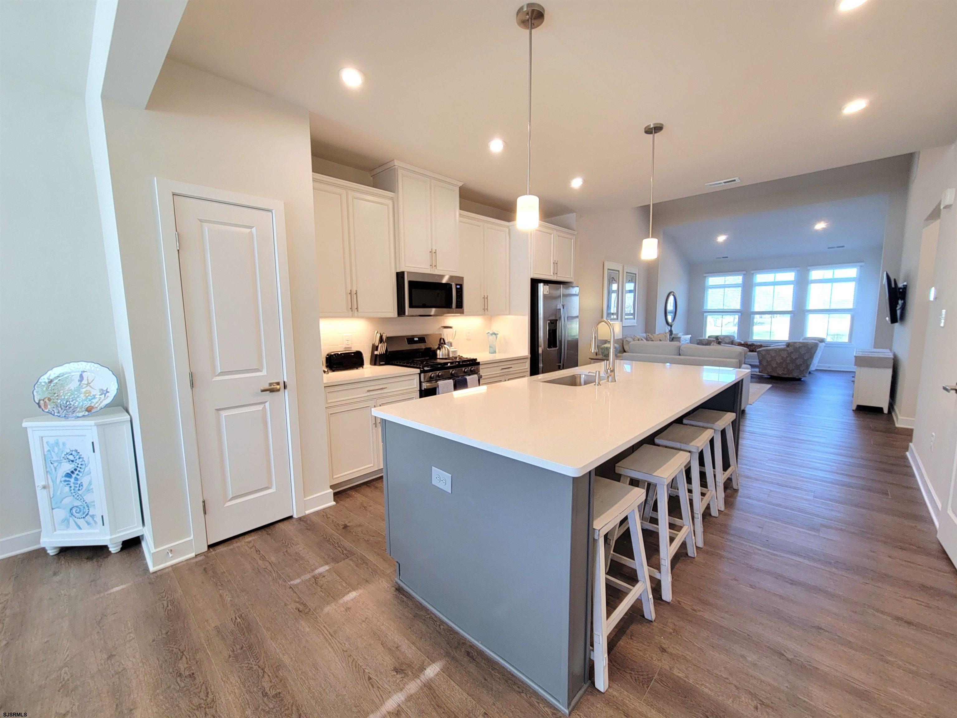 1004 Jesse Drive Somers Point, NJ 08244 - Photo 6 of 45 a kitchen with stainless steel appliances a stove top oven a sink a refrigerator a center island and wooden floor