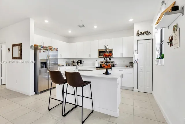 a kitchen with stainless steel appliances a refrigerator and a stove top oven