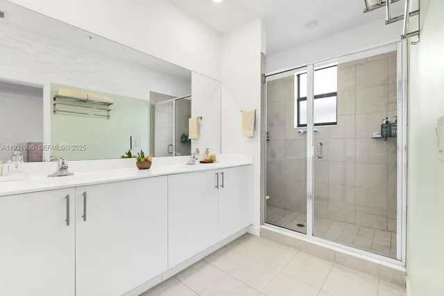 a bathroom with a shower sink and mirror