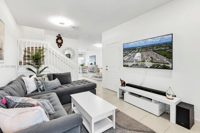 a living room with furniture and a flat screen tv