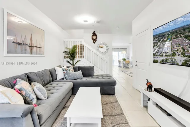 a living room with furniture and a large window